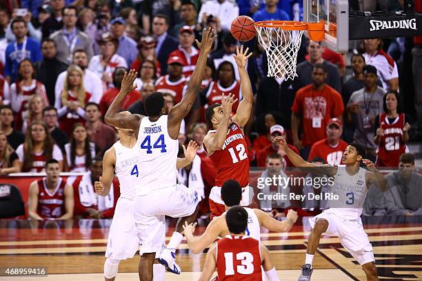 Traevon Jackson of the Wisconsin Badgers drives to the basket against Dakari Johnson of the Kentucky Wildcats during the NCAA Men's Final Four...