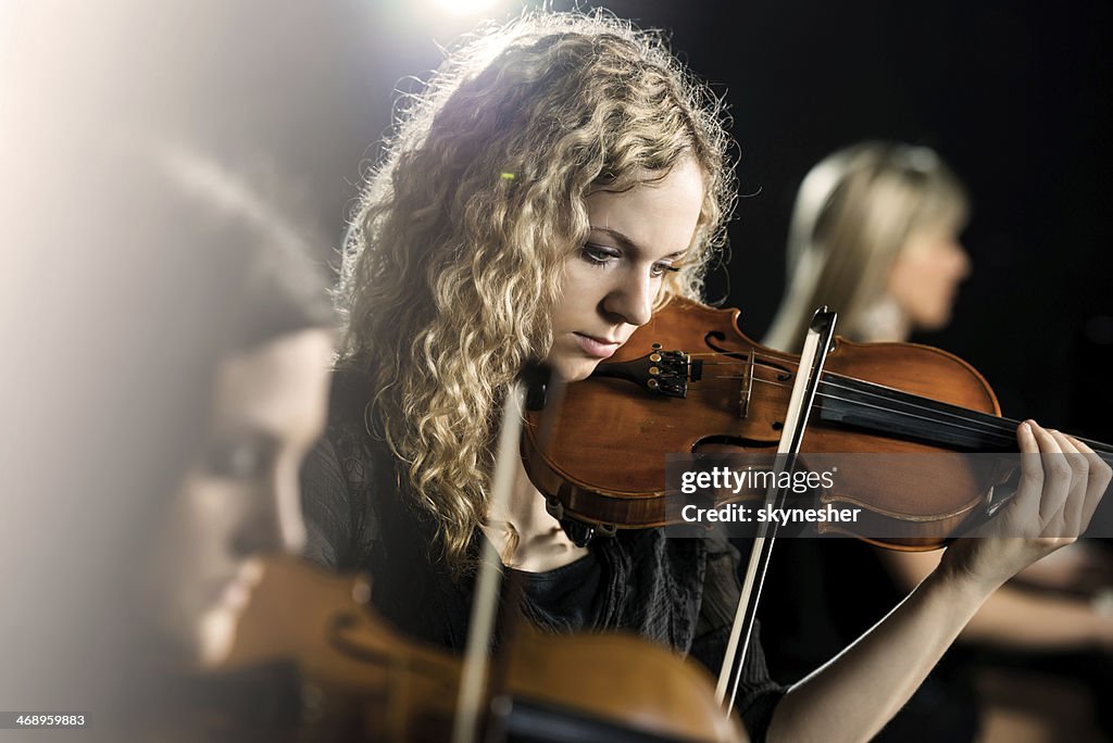 Woman playing violin.