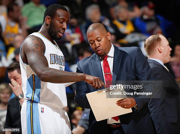 Head coach Melvin Hunt of the Denver Nuggets talks with J.J. Hickson of the Denver Nuggets during a time out against the Los Angeles Lakers at Pepsi...