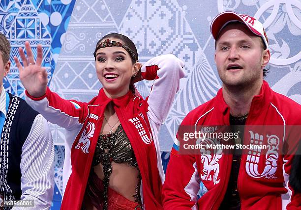 Vera Bazarova and Yuri Larionov of Russia wait for their score after competing in the Figure Skating Pairs Free Skating during day five of the 2014...