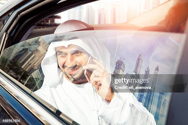 arabic businessman on phone in car,dubai - dubai marina stock pictures, royalty-free photos & images