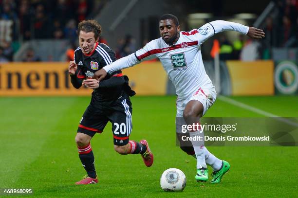 Guardado Hernandez of Bayer Leverkusen and Olivier Occean of 1. Kaiserslautern battle for the ball during the DFB Cup quarterfinal match between...