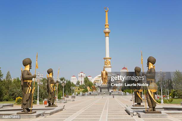 statues in front of independence monument - turkmenistan stock pictures, royalty-free photos & images