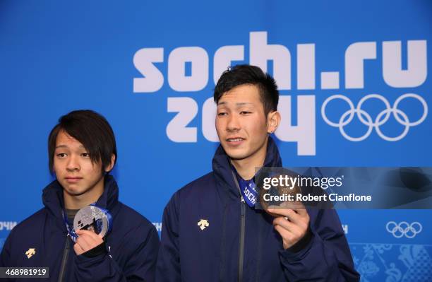 Silver medalist Ayumu Hirano of Japan and bronze medalist Taku Hiraoka of Japan celebrate on the podium during the medal ceremony for Snowboard Men's...