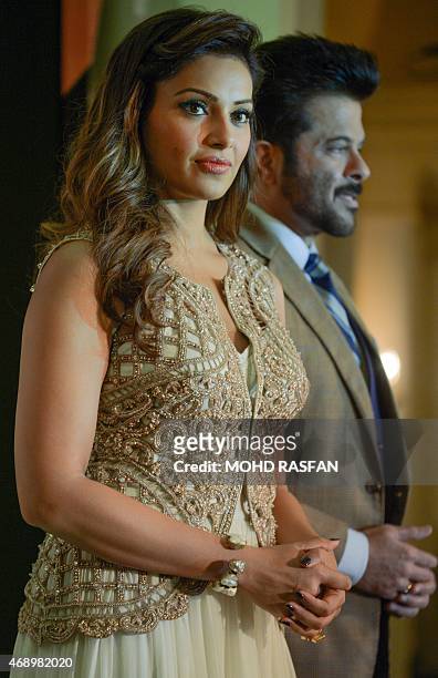 Indian Bollywood film actors Bipasha Basu and Anil Kapoor pose for pictures during a press briefing for the 16th International Indian Film Awards at...
