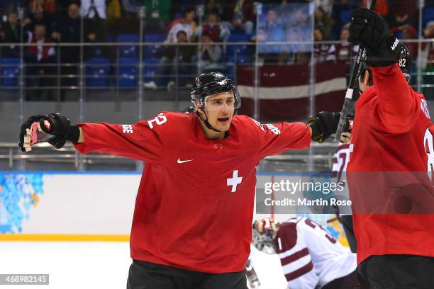 Nino Niederreiter of Switzerland celebrates after scoring a goal late in the third period against Edgars Masalskis of Latvia during the Men's Ice...