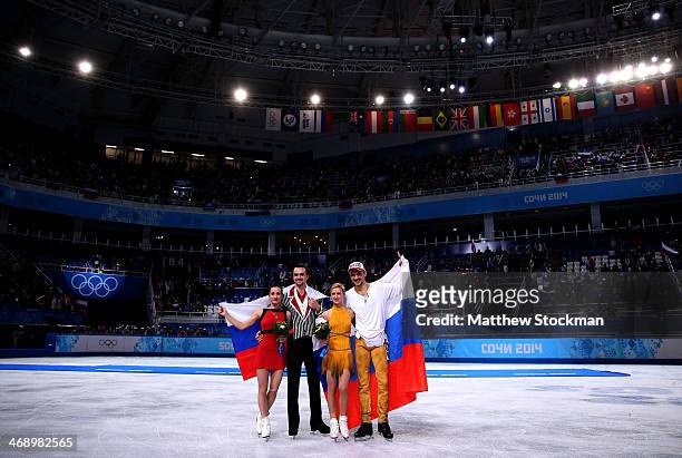 Silver medalists Ksenia Stolbova and Fedor Klimov of Russia, gold medalists Tatiana Volosozhar and Maxim Trankov of Russia pose during the flower...
