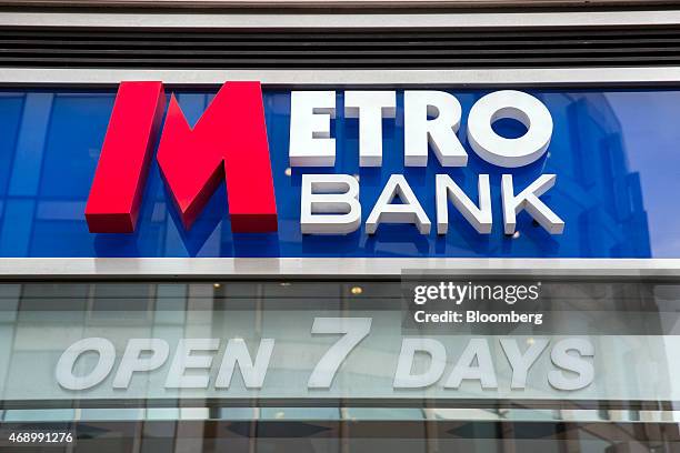 Metro Bank Logo sits above the windows of a Metro Bank Plc branch on Southampton Row in London, U.K., on March 23, 2015. Vernon Hill, chairman of...