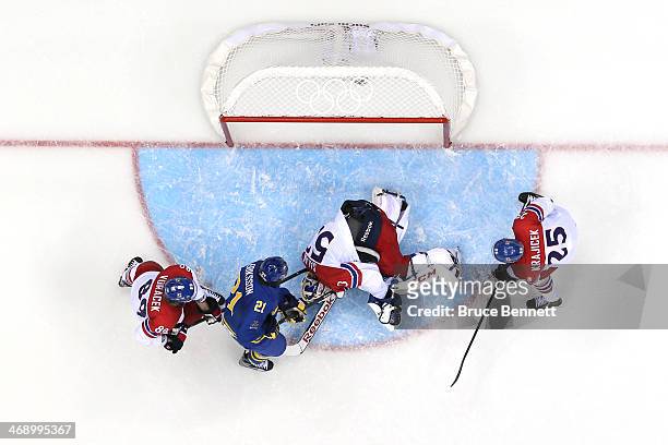 Alexander Salak of Czech Republic lays on the ice after a play at the net against Sweden during the Men's Ice Hockey Preliminary Round Group C game...