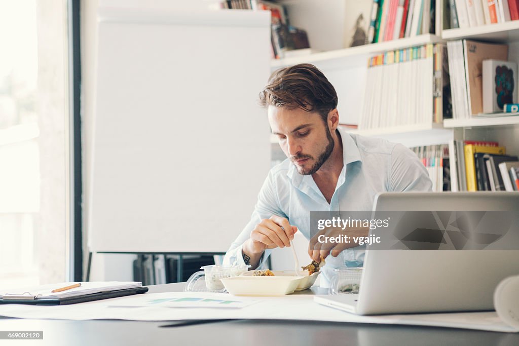 Businessman have lunch break in office.