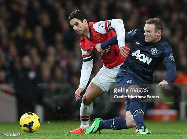 Wayne Rooney of Manchester United in action with Mikel Arteta of Arsenal during the Barclays Premier League match between Arsenal and Manchester...