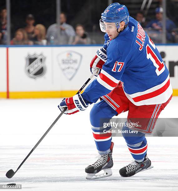 John Moore of the New York Rangers skates up the ice with the puck against the Edmonton Oilers at Madison Square Garden on February 6, 2014 in New...