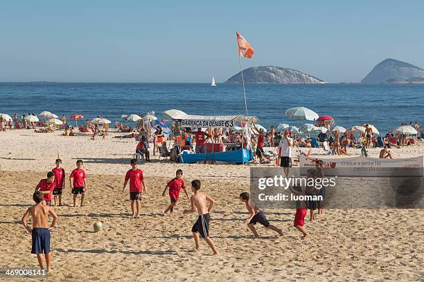 kids playing soccer in ipanema beach - brazil skyline stock pictures, royalty-free photos & images