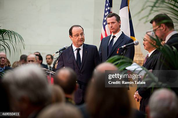 French President Francois Hollande speaks at a reception as California Lieutenant Governor Gavin Newsom and San Francisco Mayor Ed Lee listen during...