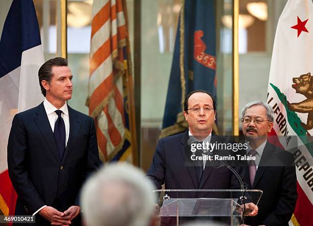 French President Francois Hollande speaks at a reception as California Lieutenant Governor Gavin Newsom and San Francisco Mayor Ed Lee listen during...