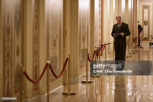Sen. Robert Casey looks at his iPad while walking thorugh the U.S. Capitol February 12, 2014 in Washington, DC. Despite objections by some in the...