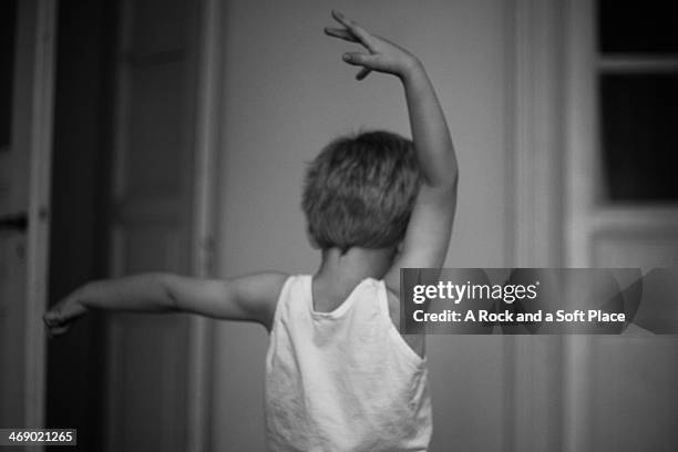 boy dances with arms in air - ballet boy stock pictures, royalty-free photos & images