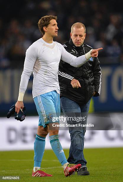 René Adler of Hamburg and Lotto King Karl look dejected at the end of the DFB Cup quarter final match between Hamburger SV and Bayern Muenchen at...