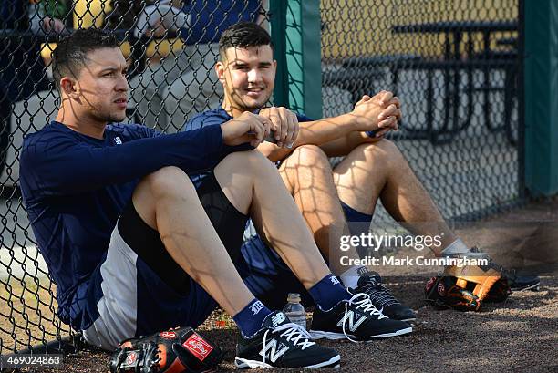 Hernan Perez and Eugenio Suarez of the Detroit Tigers sit together on the field during the Tigers Workout Day at Joker Marchant Stadium on February...