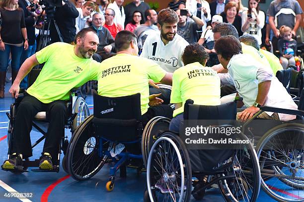 Laureus Ambassador and FC Barcelona player Gerard Pique shakes hands with his teammates during a korfball match at the Insitut Guttmann on April 9,...