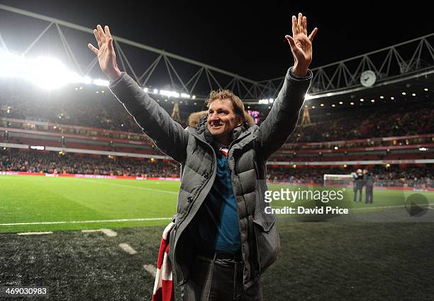 Tony Adams ex Arsenal player waves to the crowd at half time of the match between Arsenal and Manchester United in the Barclays Premier League at...
