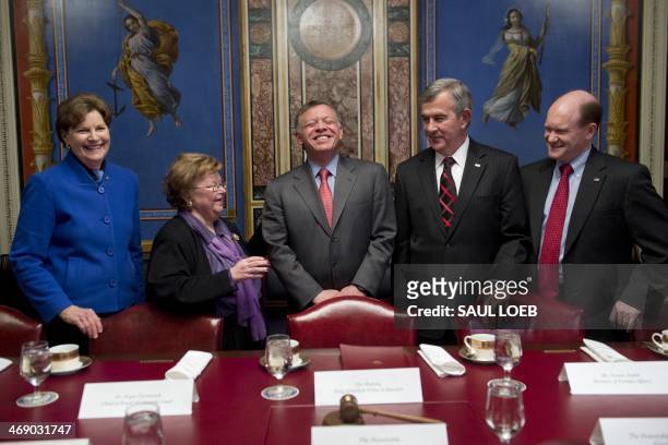 King Abdullah II of Jordan laughs alongside US Democratic Senator Barbara Mikulski of Maryland, chairwoman of the Senate Appropriations Committee,...