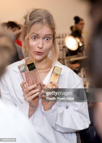 Model prepares backstage at the Michael Kors Show during Mercedes-Benz Fashion Week Fall 2014 at Spring Studios on February 12, 2014 in New York City.