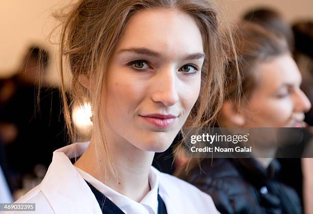 Model prepares backstage at the Michael Kors Show during Mercedes-Benz Fashion Week Fall 2014 at Spring Studios on February 12, 2014 in New York City.