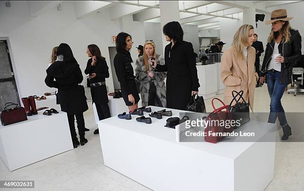 Various members of the press gather around some of the new items featured during the Newbark presentation during Mercedes-Benz Fashion Week Fall 2014...