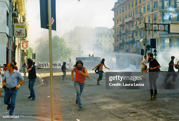 Anti-G8 protester runs away during clashes with police on the second day of the G8 Summit on July 21, 2001 in Genoa, Italy. Thousands of anti G8...