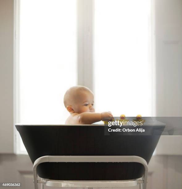 baby taking a bath - baby bath toys stock pictures, royalty-free photos & images