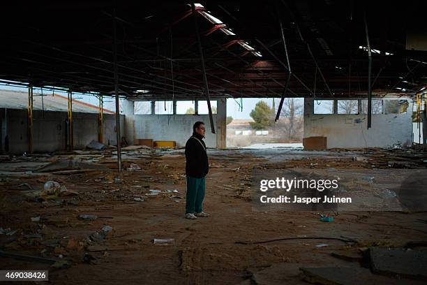 Former door factory workers Angel Perez Fernandez walks inside the abandoned Puertas Mavisa door factory hall on December 22 in Villacanas,, Spain....