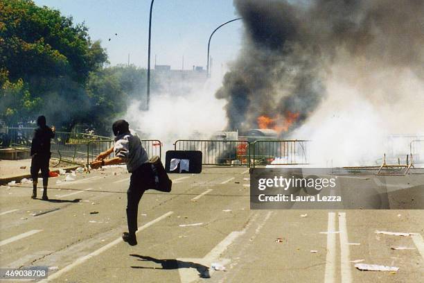 Anti-G8 protester throws stones against the police during clashes with police on the second day of the G8 Summit on July 21, 2001 in Genoa, Italy....
