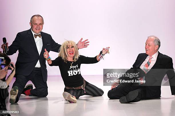 Betsey Johnson does the splits on the runway with the director's from Marist College at Betsey Johnson Reprise during Mercedes-Benz Fashion Week Fall...