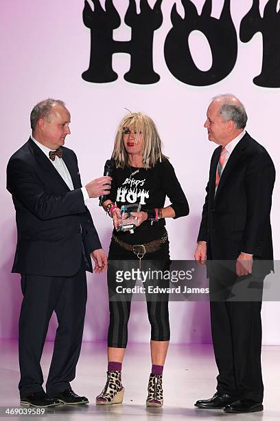 Designer Betsey Johnson receives the Silver Needle Award from the directors of Marist College during the Betsey Johnson Reprise fashion show during...