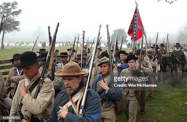 American Civil War re-enactors acting as members of the North Carolina 26th Infantry leave the field of battle following a re-enactment of the Battle...