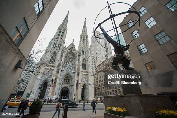 Pedestrians walk past Saint Patrick's Cathedral during a massive restoration effort in New York, U.S., on Tuesday, April 7, 2015. The $180 million...