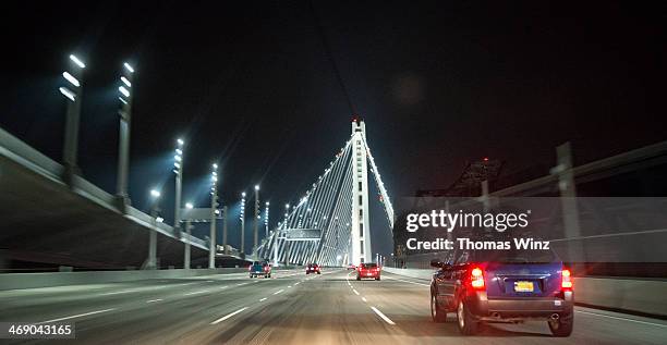 driving on a bridge at nights - san francisco bridge fotografías e imágenes de stock