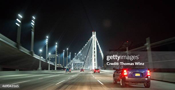 driving on a bridge at nights - bay bridge stock pictures, royalty-free photos & images