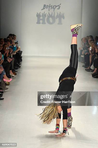 Designer Betsey Johnson cartwheels down the runway at the Marist College Presents Betsey Johnson Reprise fashion show during Mercedes-Benz Fashion...
