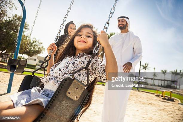 happy young traditional family in dubai, uae - beautiful arabian girls stock pictures, royalty-free photos & images