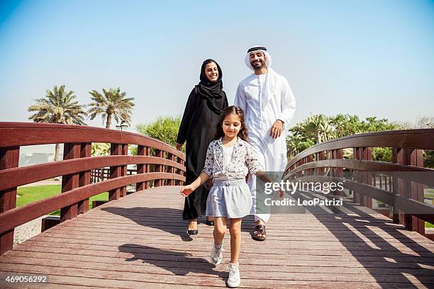 happy young traditional family in dubai, uae - förenade arabemiraten bildbanksfoton och bilder