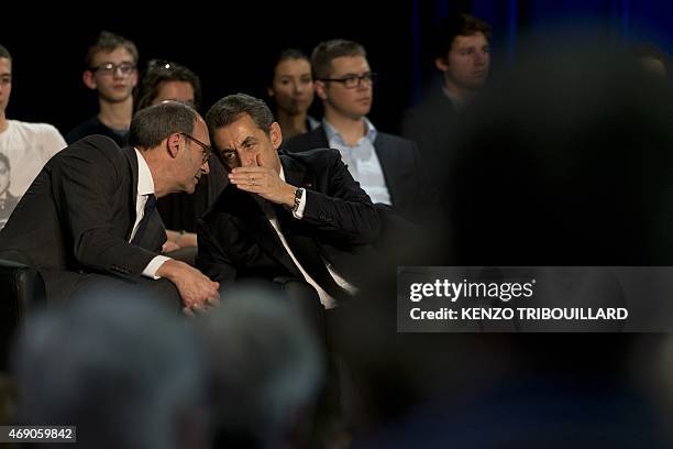 Former French President and current UMP right-wing party President, Nicolas Sarkozy speaks with Former French budget minister Eric Woerth during a...