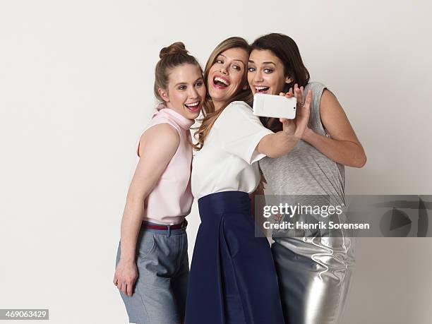 three young women taking a selfie - silver skirt stock pictures, royalty-free photos & images
