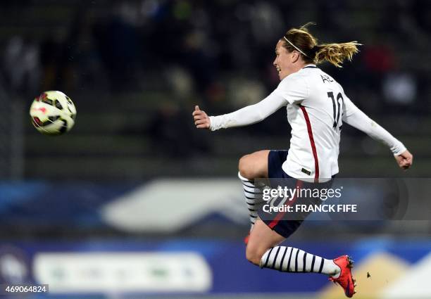 France's midfielder Camille Abily jumps for the ball during the friendly football match France vs Canada, on April 9, 2015 at the Stade Robert-Bobin...