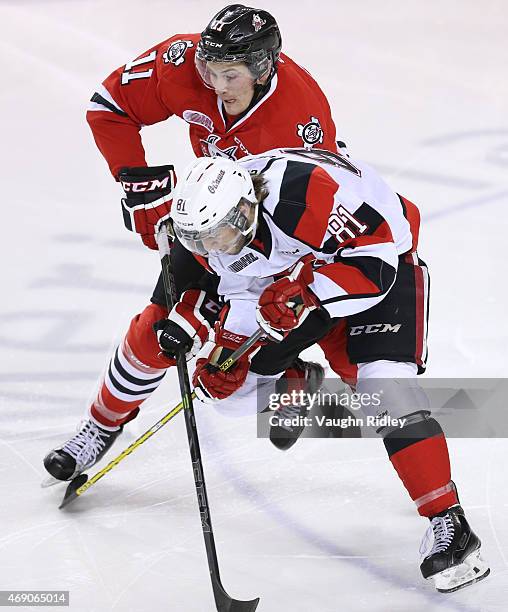 Nathan Todd of the Ottawa 67's battles for the puck with Brendan Perlini of the Niagara IceDogs during Game 6 of the Eastern Conference...