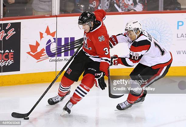 Brian Brosnan of the Niagara IceDogs and Jeremiah Addison of the Ottawa 67's battle for the puck during Game 6 of the Eastern Conference...