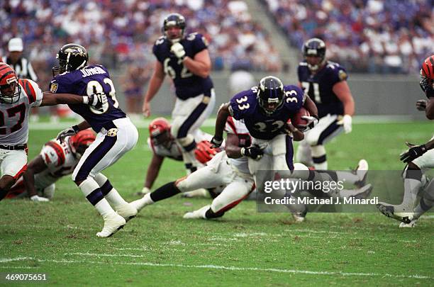 Runningback Priest Holmes of the Baltimore Ravens runs the ball down the middle for a few extra yards during a NFL game against the Cincinnati...