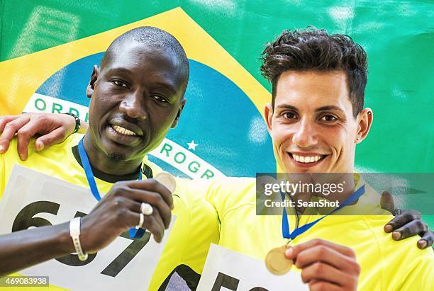 athletes showing medals - marathon medal stock pictures, royalty-free photos & images