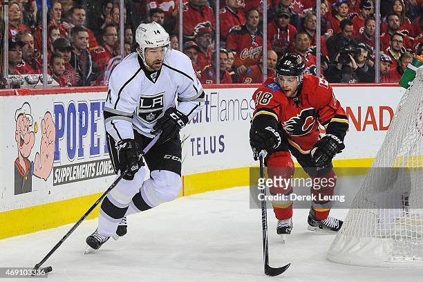 Matt Stajan of the Calgary Flames chases Justin Williams of the Los Angeles Kings during an NHL game at Scotiabank Saddledome on April 9, 2015 in...
